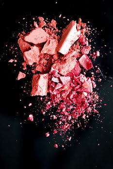 Crushed cosmetics, mineral organic eyeshadow, blush and cosmetic powder isolated on black background, makeup and beauty banner, flatlay design.