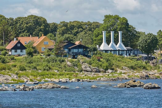 The roofs and chimneys of very small smoke houses so typical and famous for small village of Svaneke on Bornholm island in Denmark.