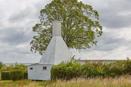 The roofs and chimneys of very small smoke houses so typical and famous for small village of Svaneke on Bornholm island in Denmark.