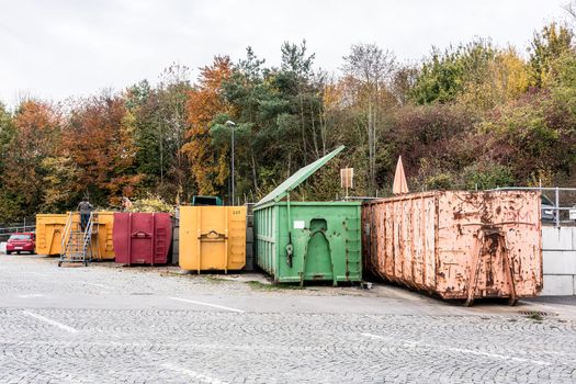 Containers of different color on recycling center