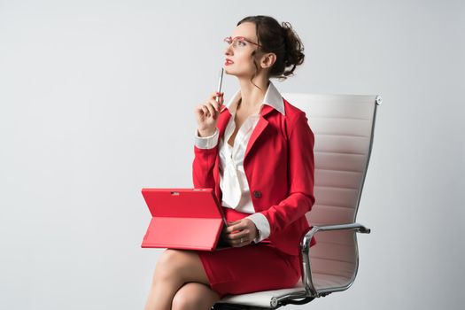 Businesswoman with laptop computer thinking pensively