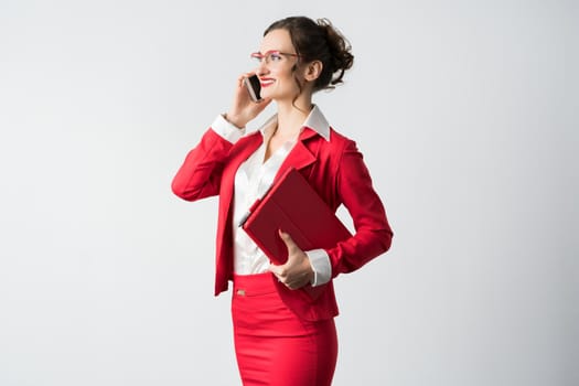 Businesswoman in red suit on the phone