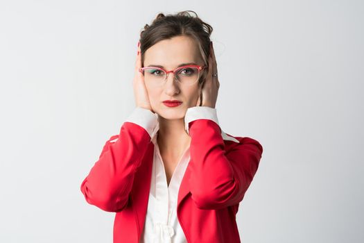 Businesswoman hear no evil covering her ears