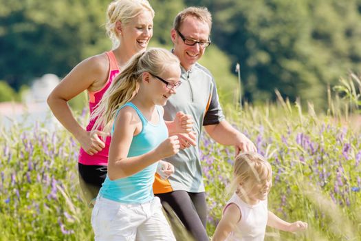Parents with two children sport running outdoors