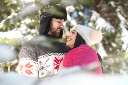 Romantic happy cheerful couple looking at each other spending time in the forest