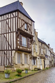 Street with historical half-timbered houses in Noyers (Noyers-sur-Serein), Yonne, France