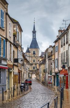 Street with historical clock tower in Avallon, France