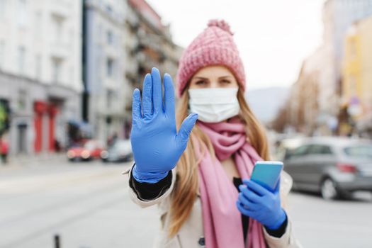 Woman in lockdown city wearing medical mask asking for social distancing