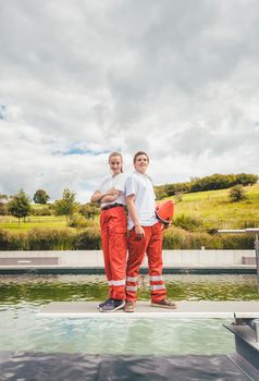 Lifeguards standing on the poolside ready to help