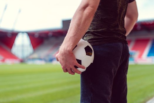 Soccer player with ball in stadium waiting for the game to begin or the season to open