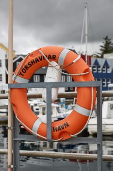 Lifering in port area with name of town of Torshavn, Faroe Islands, Denmark written on it.