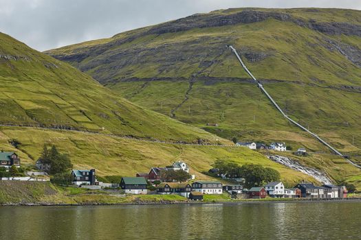 Village in wild and beautiful landscape of Faroe Islands, Denmark.