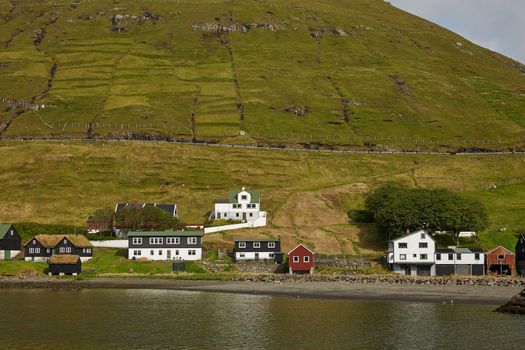 Village in wild and beautiful landscape of Faroe Islands, Denmark.