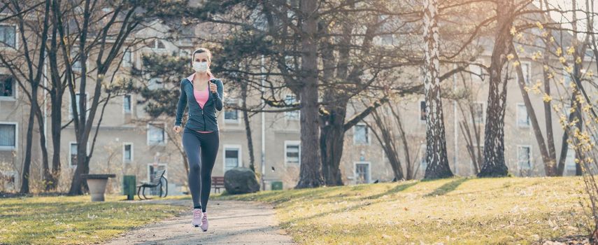 Woman jogging down a path boosting her immune system and fitness for covid-19