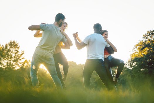 Professional dancers training outdoors in the park