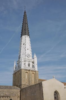 Church of Ars with black and white bell tower in the Ile de Re in Charente France.