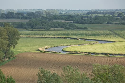 Beautiful countryside landscape with fields and small river near Kiel - Schleswig-Holstein - Germany.