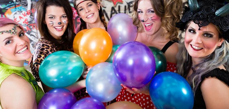 Group of cheerful women at Rose Monday making party with balloons