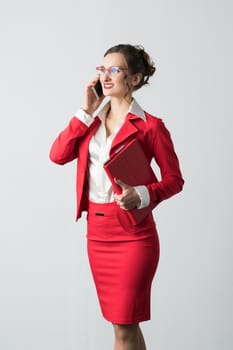 Businesswoman in red suit on the phone