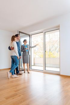 Young couple getting tour through apartment they consider renting or purchasing