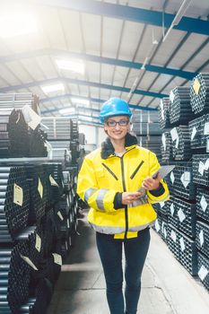 Woman working in logistics warehouse for building materials