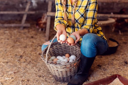 Proud chicken farmer woman showing the organic eggs her hens produced