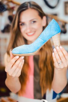 Happy woman shopping for shoes falls in love with blue high heels