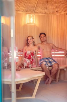 Couple of Caucasian woman and Asian man enjoying a very luxurious sauna