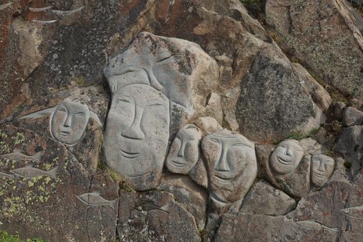 Images of faces chiseled into rocks, Qaqortoq Greenland.