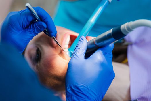 Beautiful woman at the dentist in prophylaxis session being looked after