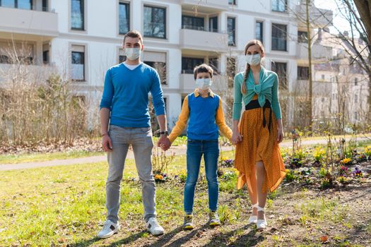 Family during coronavirus crises having a walk enjoying life