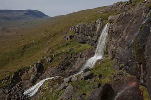 Beautiful cascade waterfall Bleiksarfoss in Eskifjordur, east of Iceland.