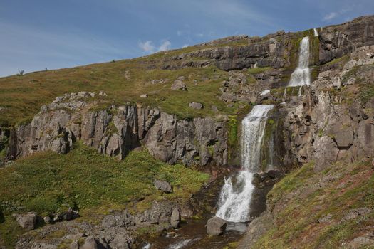 Beautiful cascade waterfall Bleiksarfoss in Eskifjordur, east of Iceland.