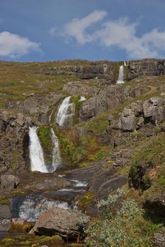 Beautiful cascade waterfall Bleiksarfoss in Eskifjordur, east of Iceland.