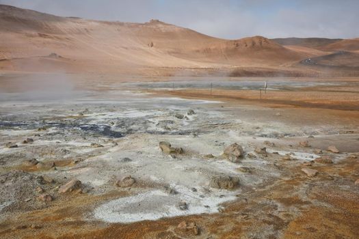 Námaskarð. Fumarole field in Namafjall, Iceland. Namaskard geothermal beauty landscape with mud pools and steam. Icelandic brown landscape. Landscape which pools of boiling mud and hot springs.