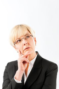 Close-up of thoughtful mature businesswoman against white background