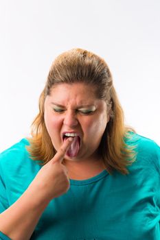 Portrait of fatty woman feeling nausea touching her tongue with finger