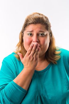 Worried woman with her hand over mouth isolated over white background