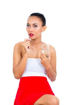 Woman holding glass of a water and pill on white background