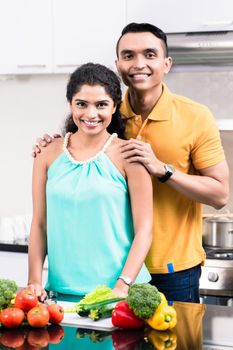 Portrait of a smiling young couple in kitchen
