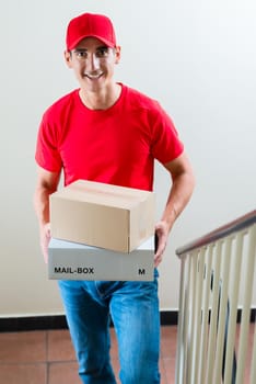 Happy portrait of male courier with two cardboard boxes