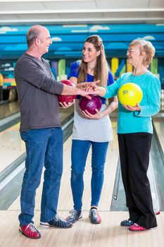 Smiling family stacking their hands while playing indoor games