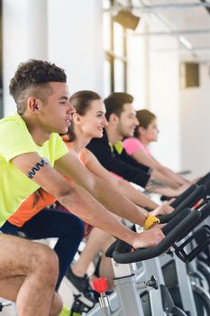 Group of people exercising on bicycle at the fitness gym