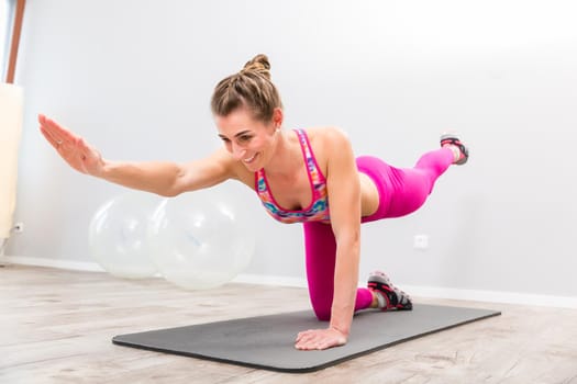 Young woman wearing sportswear clothes exercising in the gym