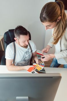 Creatives working in team checking colors for advertising project in the agency