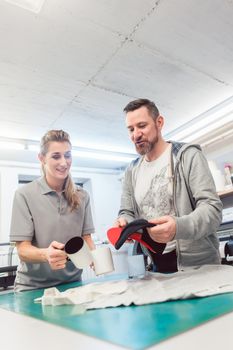 Man and woman discussing which promotional items to use in creative brainstorm