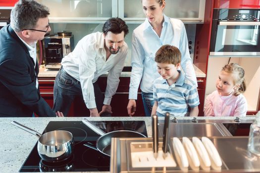 Family shopping for a new kitchen looking at details