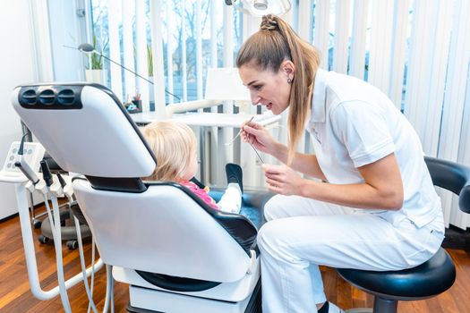 Dentist treating a little child in her office