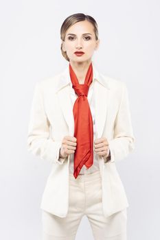 Elegant and expensive model wearing white business suit in studio shot