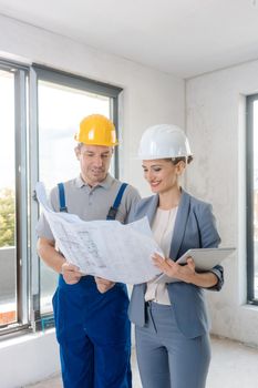 Project owner and construction worker during acceptance checking quality of work